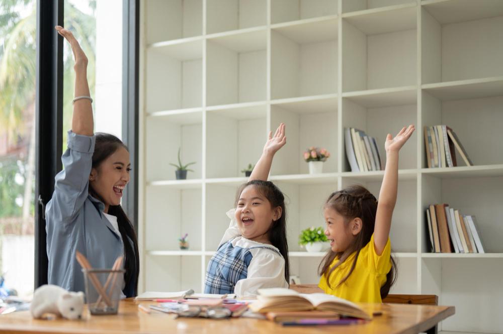 Napping & Children - Yay or Nay? 1 two happy asian girls kind female teacher are raising their hands after class finishes